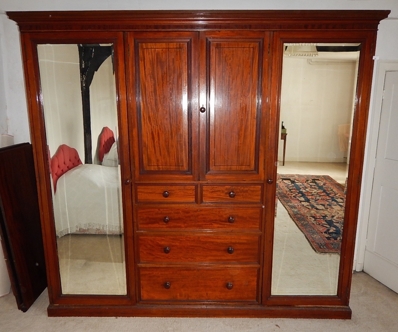 Appraisal: An early thC mahogany wardrobe with two hanging compartments enclosed