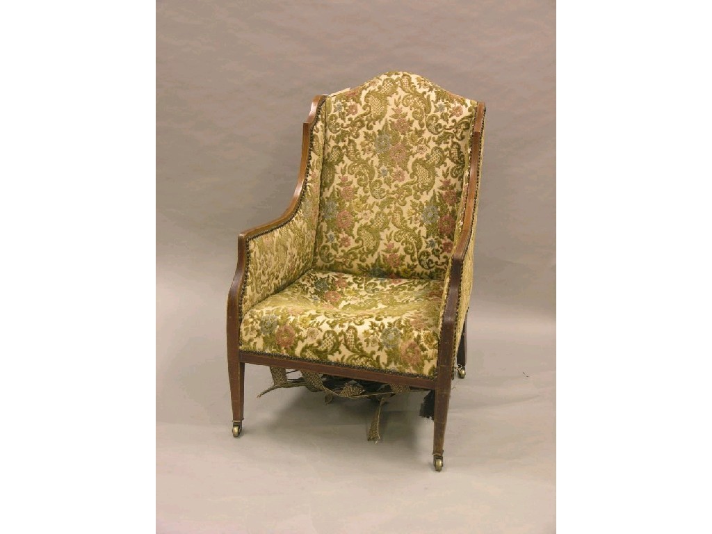 Appraisal: An Edwardian upholstered armchair inlaid mahogany frame on front square