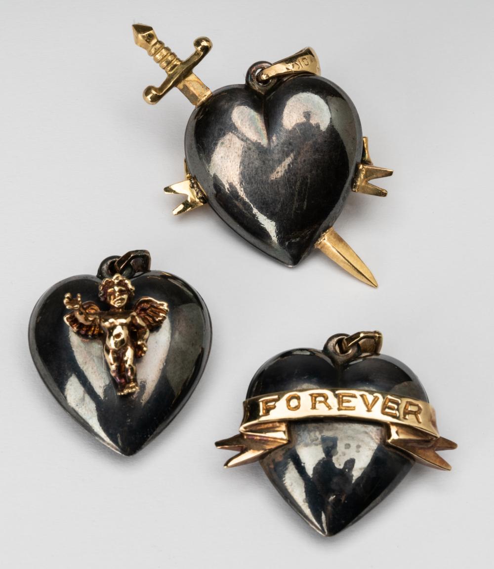 Appraisal: THREE KARAT YELLOW GOLD BLACKENED SILVER HEART-SHAPED PENDANTSIncluding a sterling