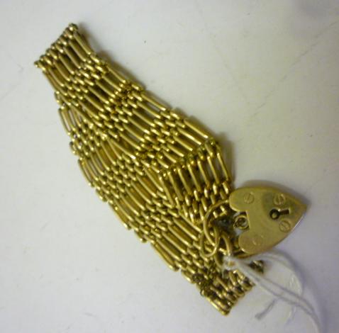 Appraisal: A CT GOLD SEVEN BAR GATE BRACELET with padlock fastener