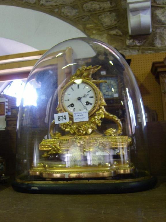 Appraisal: A mid th century gilt brass mantle clock with floral