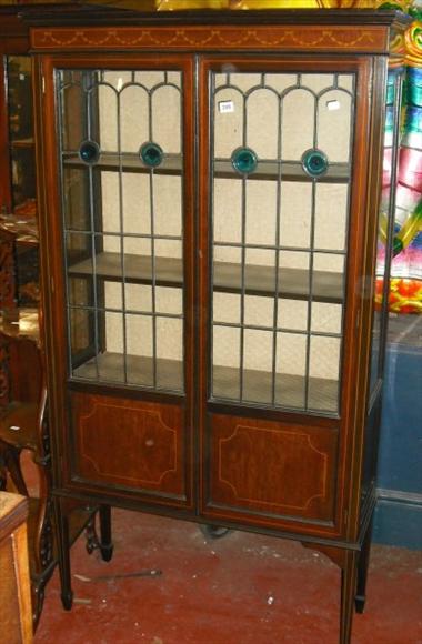 Appraisal: A Victorian marquetry decorated display cabinet with leaded and stained