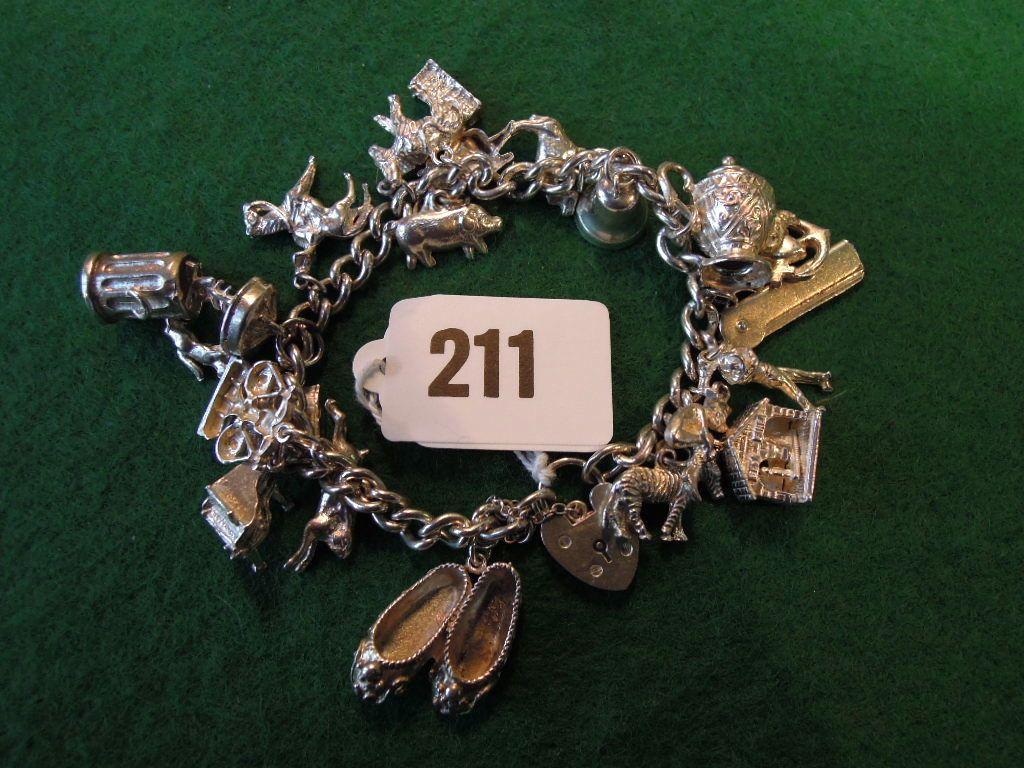 Appraisal: A silver bracelet hung with a variety of charms unmarked