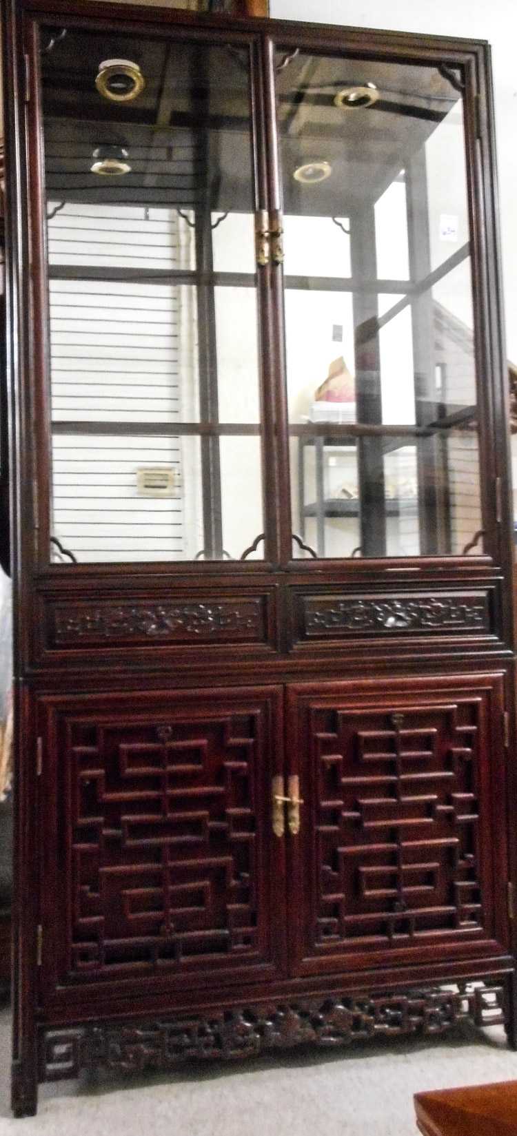 Appraisal: CHINESE ROSEWOOD DISPLAY CABINET ON CABINET the upper cabinet fitted