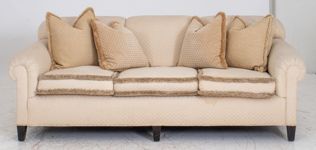 Appraisal: CREAM UPHOLSTERED ROLL-ARM SOFA Cream upholstered three seater sofa with