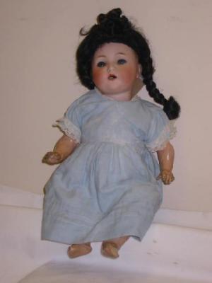 Appraisal: A German bisque head girl doll with blue glass sleeping