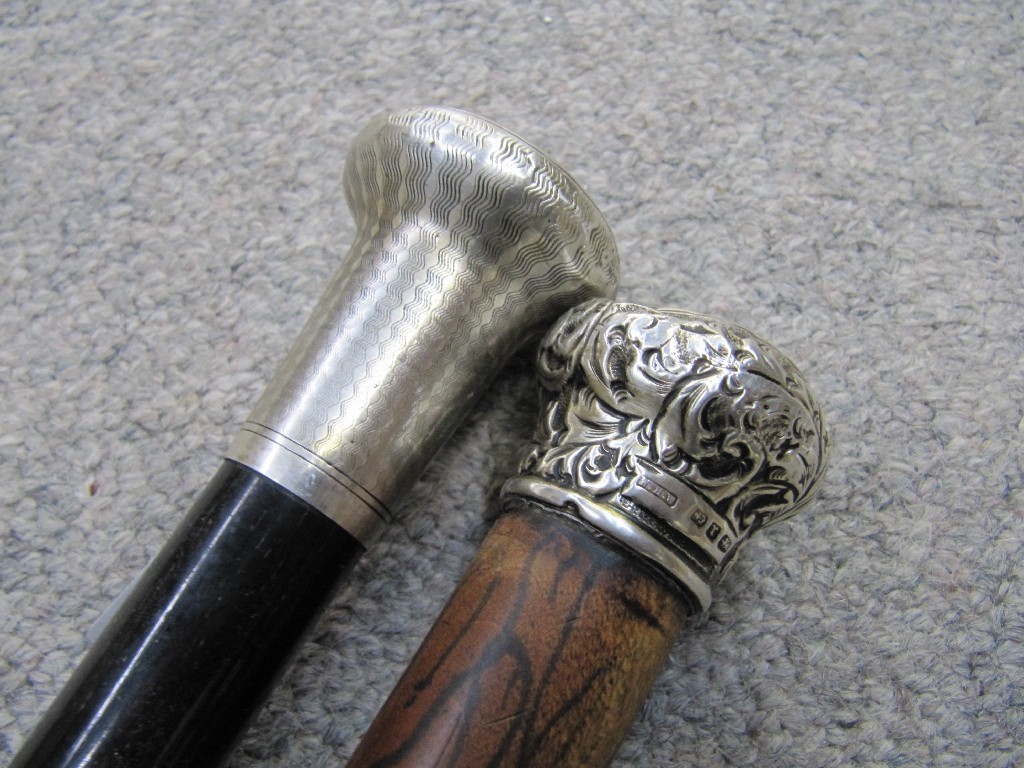 Appraisal: Lot comprising two silver topped walking canes