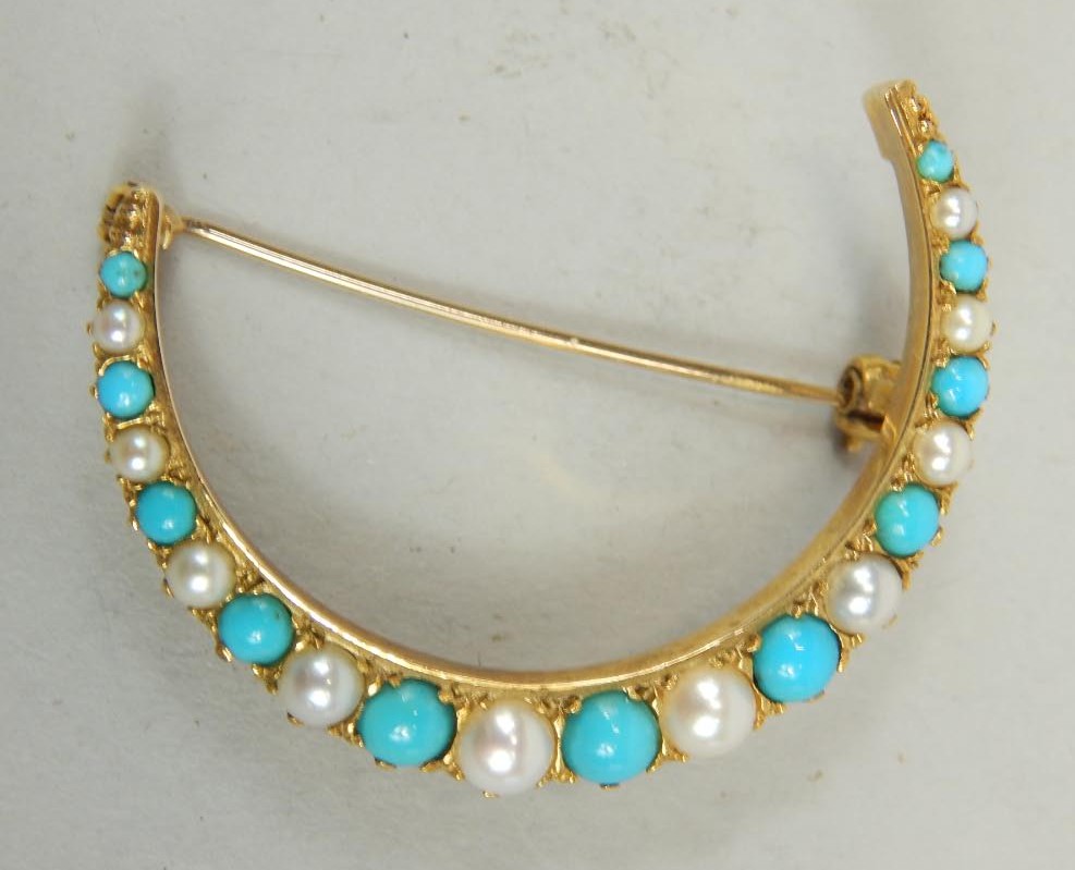 Appraisal: A Victorian style crescent brooch set with turquoise and seed