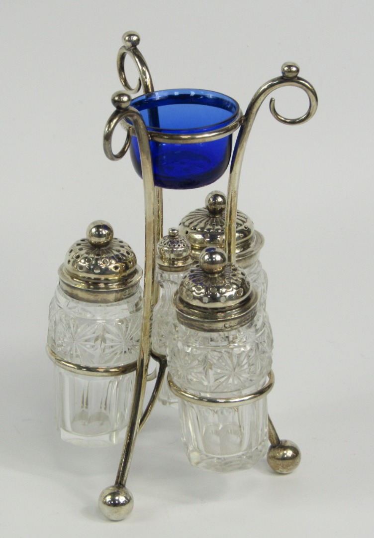 Appraisal: A Victorian silver and cut glass cruet set raised on