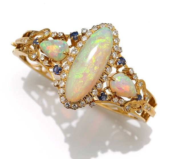 Appraisal: An opal sapphire and diamond bangle bracelet centering an oval-shaped