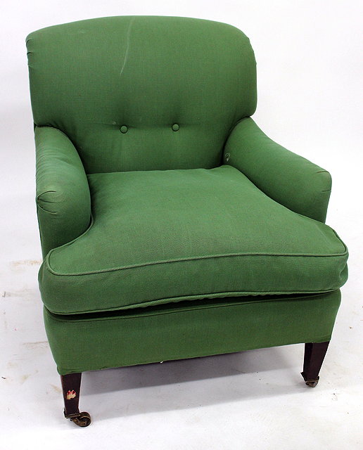 Appraisal: A GREEN UPHOLSTERED ARMCHAIR with square tapering front legs terminating