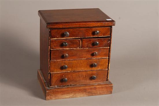 Appraisal: MINIATURE CHEST OF DRAWERS Walnut with graduated series of drawers