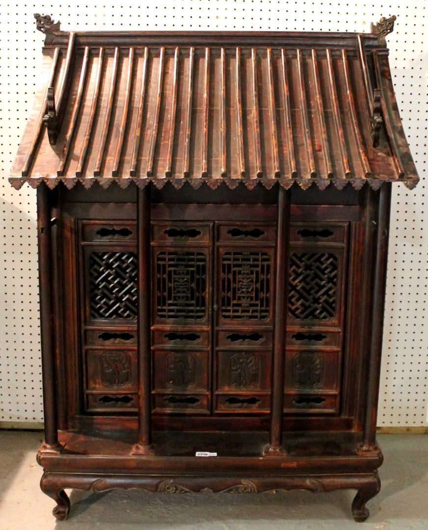 Appraisal: A th century Chinese carved hardwood shrine cabinet in the