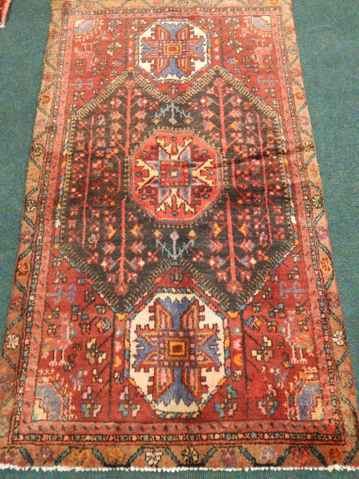 Appraisal: A Hamedan rug in ink blue and red with a