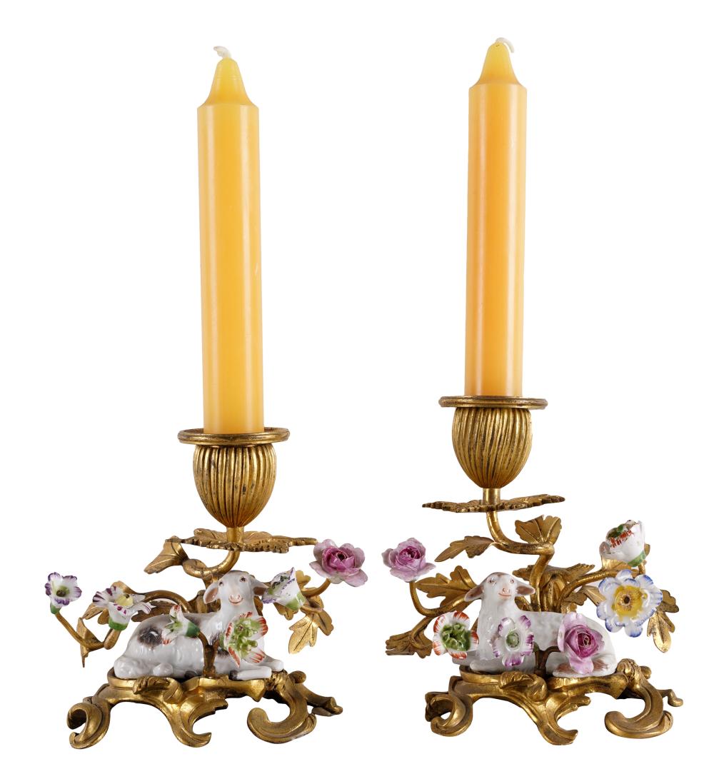 Appraisal: PAIR OF GILT METAL PORCELAIN CANDLESTICKSeach with a figure of