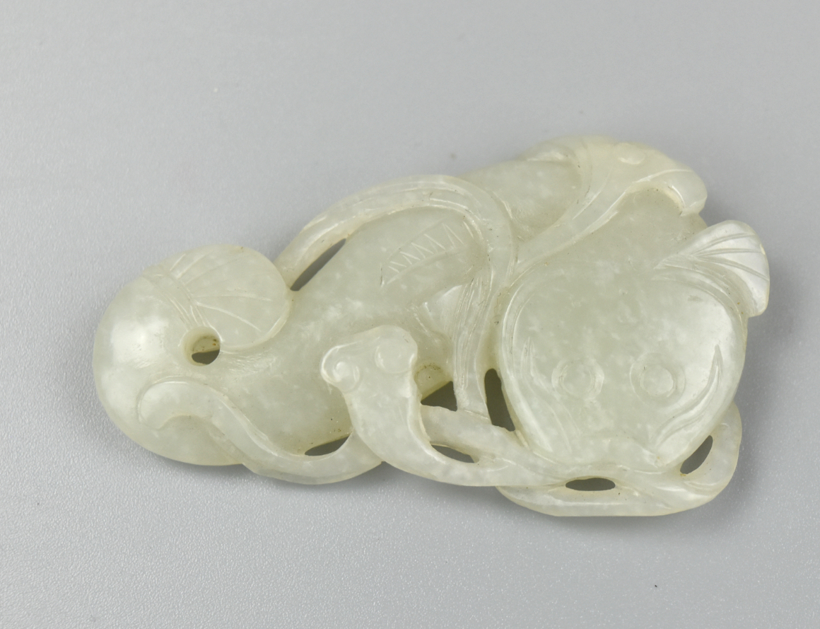 Appraisal: Chinese white jade pendant of a fish carrying lotus flower