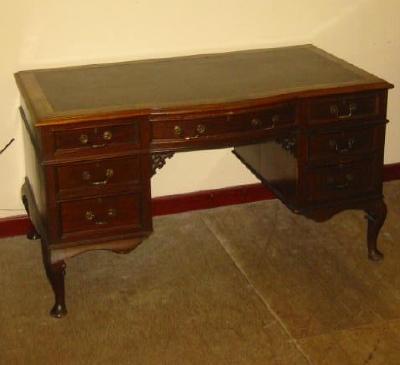 Appraisal: A MAHOGANY KNEEHOLE DESK the moulded edged and banded top