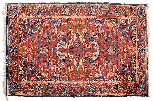 Appraisal: AN AFGHAN BLOOD RED GROUND RUG with two rows of