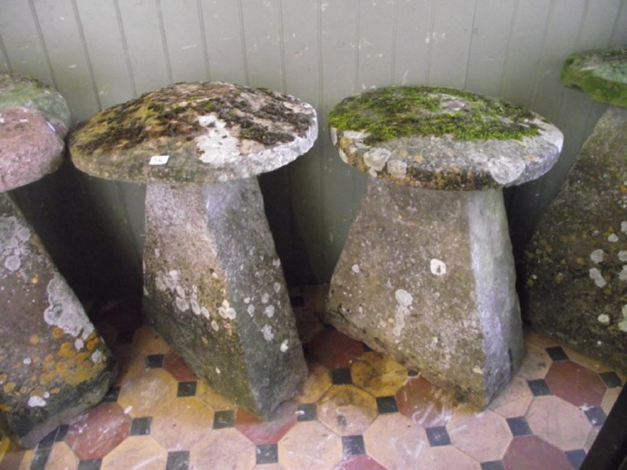 Appraisal: Two similar weathered natural stone staddle stones with tapered bases