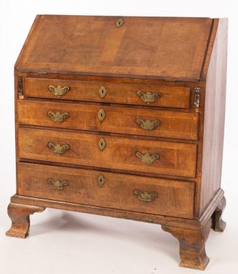 Appraisal: A George II walnut bureau with sloping flap and four