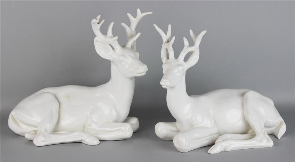 Appraisal: PAIR OF TIN GLAZED POTTERY MODELS OF STAGS recumbent to