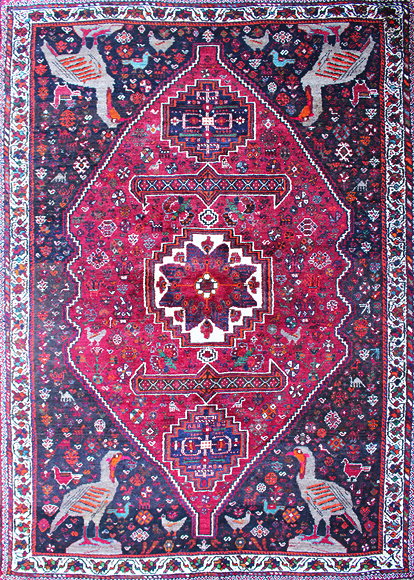 Appraisal: AN ORIENTAL WINE GROUND RUG with central diamond design and