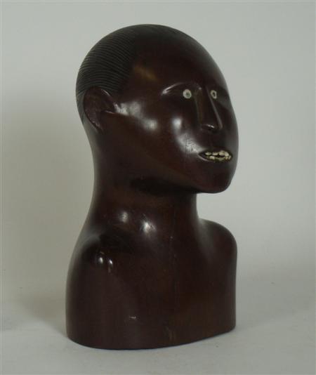 Appraisal: An East African carved hardwood head with inlaid eyes and