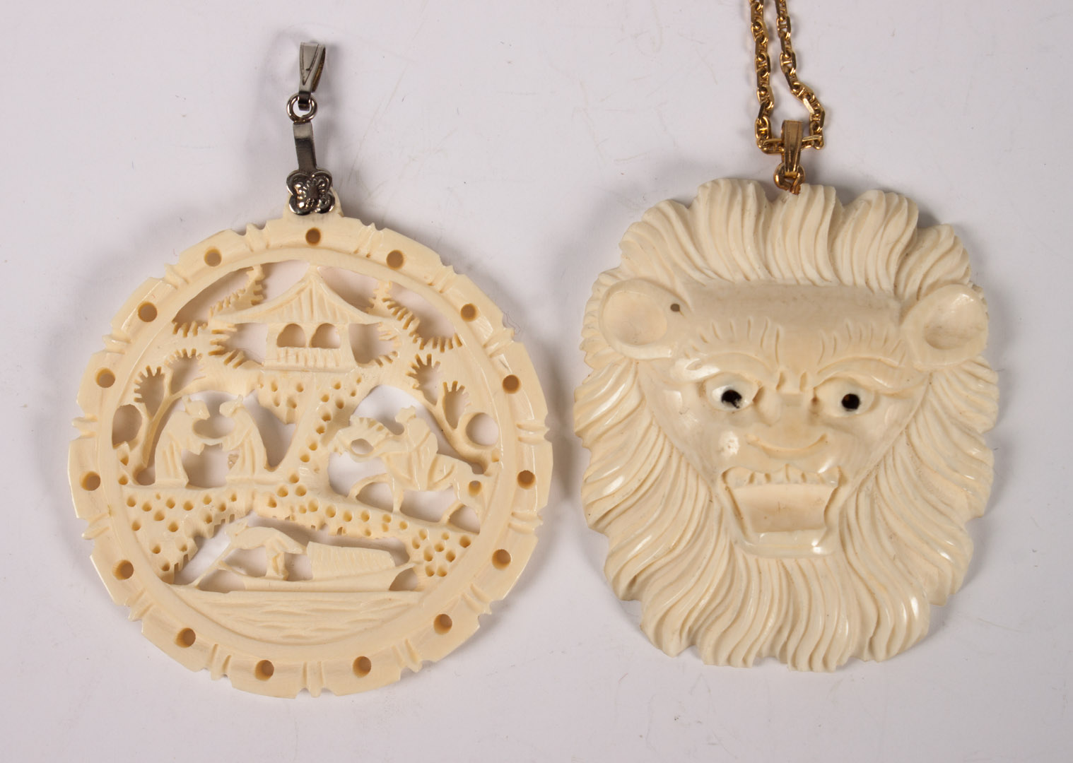 Appraisal: Two carved ivory pendants and a K gold chain carved