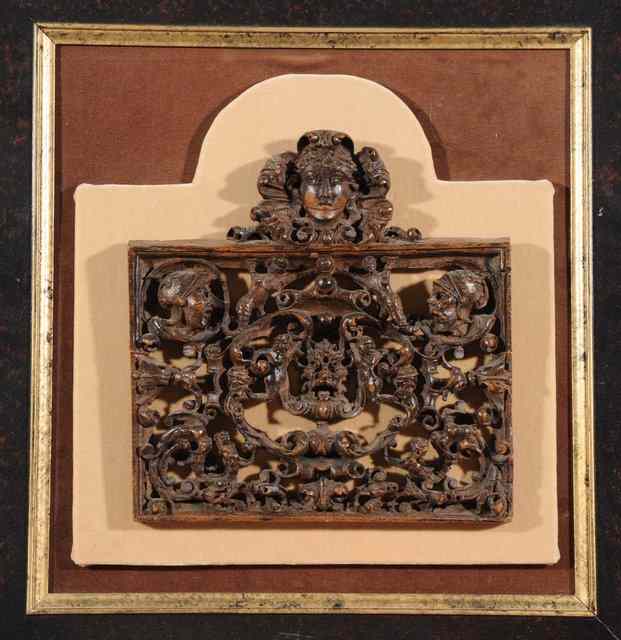 Appraisal: A PIERCED CARVED WOODEN RENAISSANCE PANEL with masks and scrolling