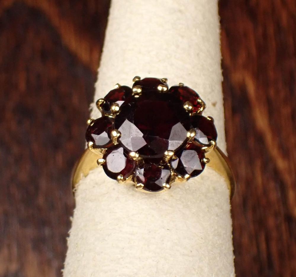 Appraisal: PYROPE GARNET AND EIGHTEEN KARAT GOLD RING The yellow gold