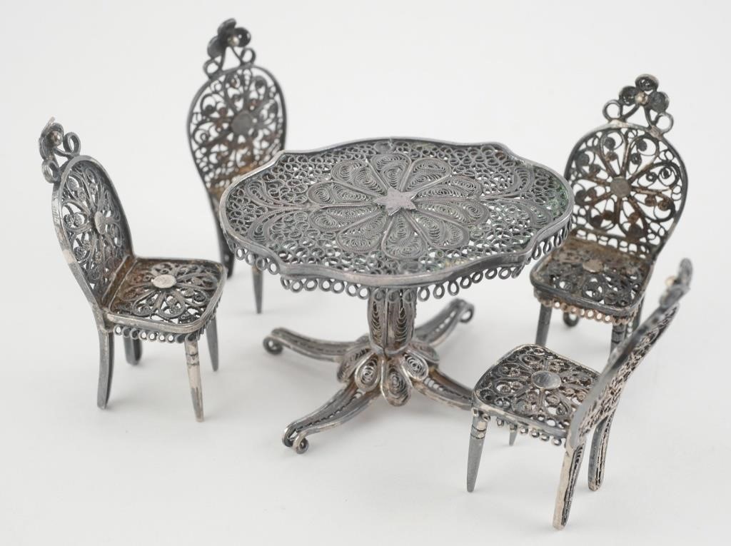 Appraisal: Sterling silver miniature furniture set featuring a table and four