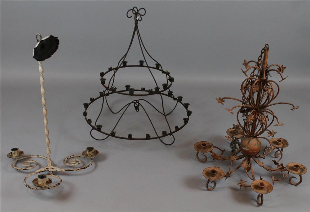 Appraisal: THREE IRONWORK PRIMITIVE CHANDELIERS one with two round tiers with