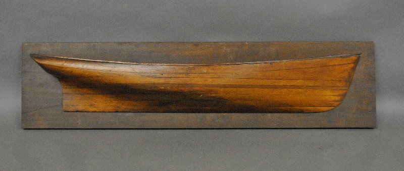 Appraisal: - Laminated pine half-hull model th c mounted on a