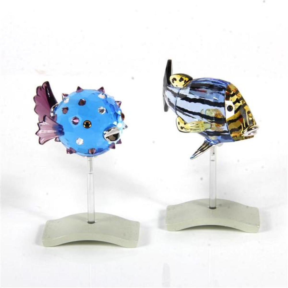 Appraisal: TWO SWAROVSKI CRYSTAL FISH FIGURINES ON STANDS CATUMBELA SAPPHIRE AND