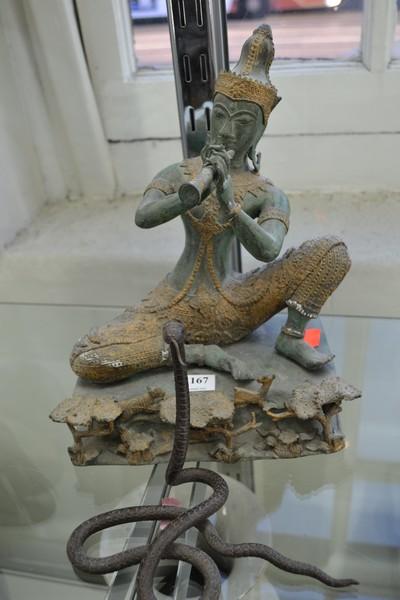 Appraisal: A BRONZE BUDDHA CHARMING A MARRIED SNAKE