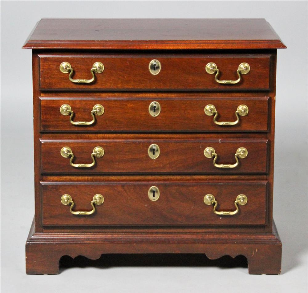 Appraisal: GEORGIAN STYLE MAHOGANY MINIATURE CHEST BY COUNCILL having a rectangular