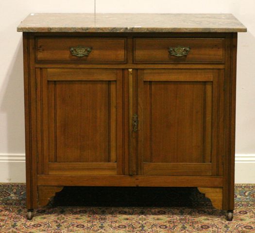 Appraisal: An Edwardian walnut and marble topped wash stand cm wide