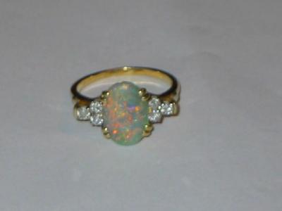 Appraisal: AN OPAL AND DIAMOND RING the oval polished opal claw