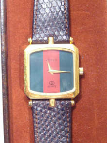 Appraisal: A gold plated gents Gucci wristwatch in original box