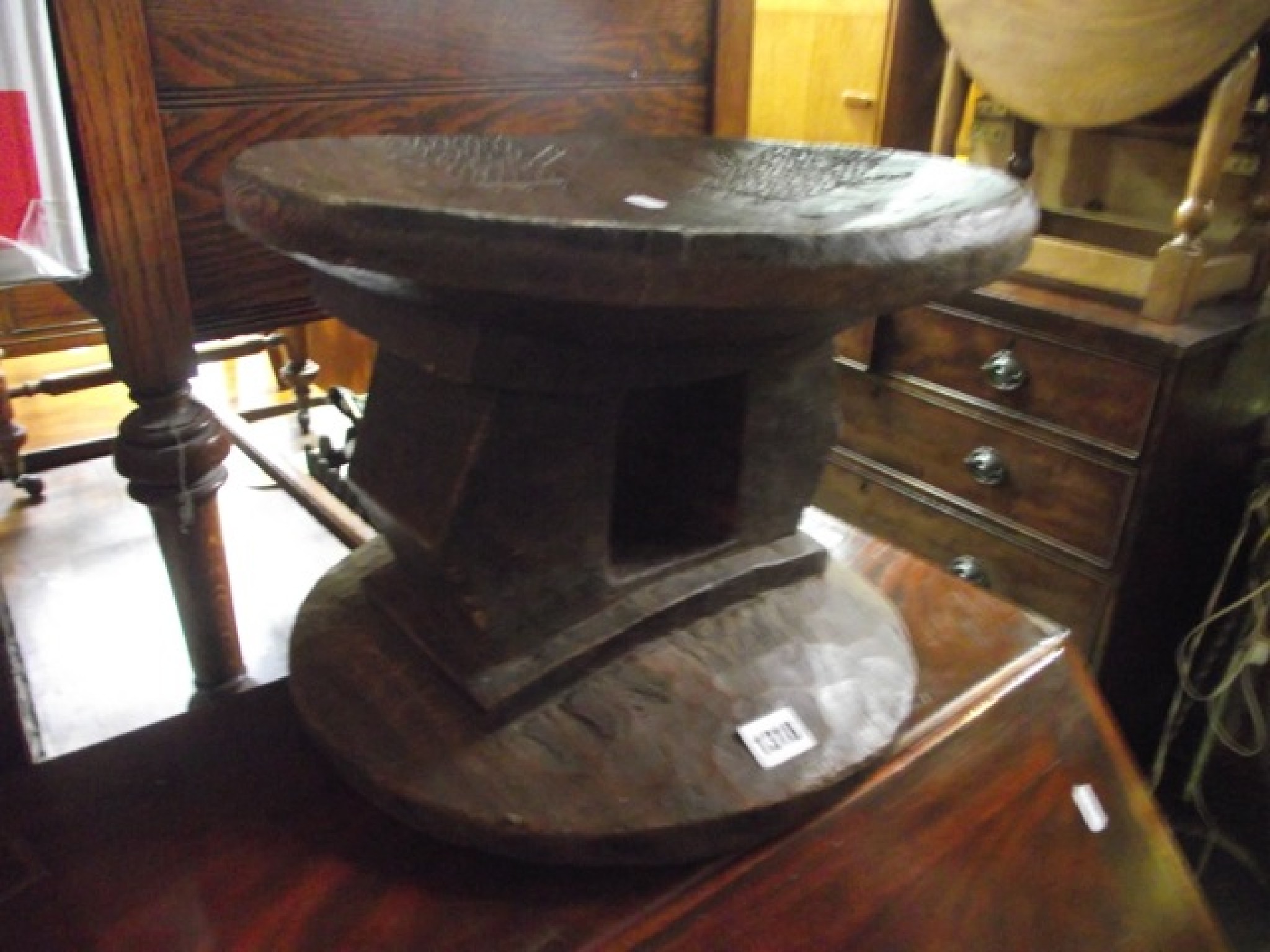 Appraisal: A carved wooden ethnic stool the dished seat with carved