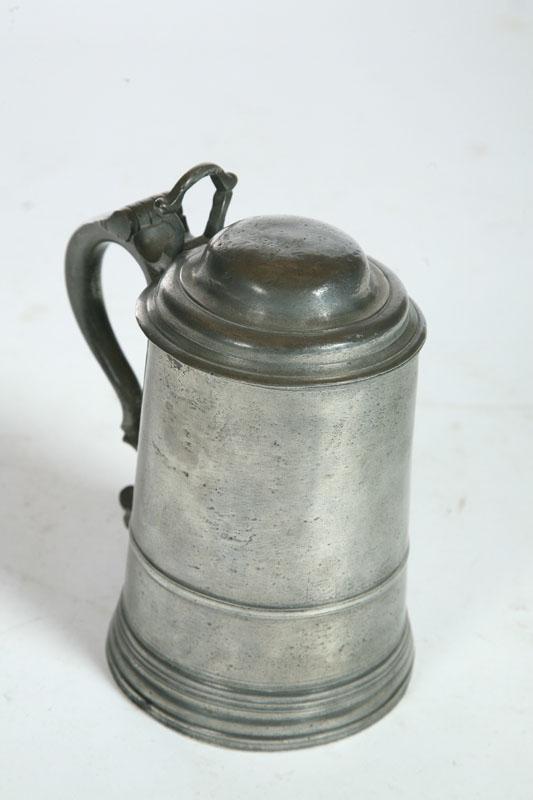 Appraisal: PEWTER TANKARD American th century Lidded tankard with scroll handle