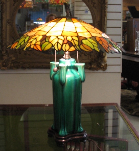 Appraisal: A GREEN POTTERY BASED TABLE LAMP fitted with hand crafted