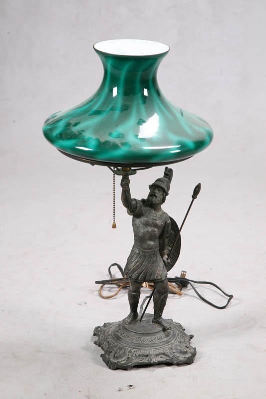 Appraisal: FIGURAL TABLE LAMP White metal warrior with a green cased