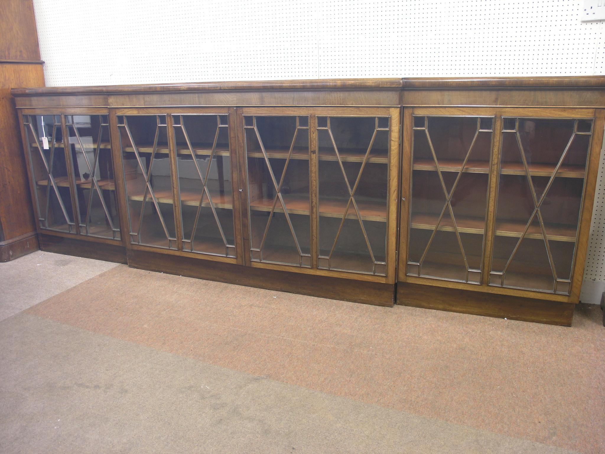 Appraisal: A George III break-fronted mahogany bookcase modified adjustable shelves enclosed