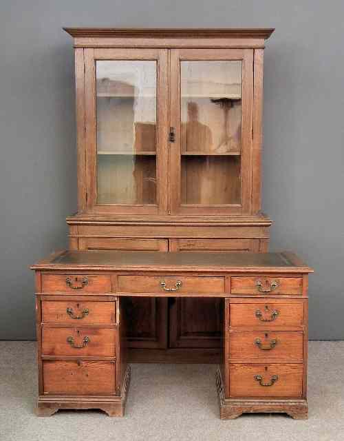 Appraisal: An early th Century oak kneehole desk with green leather