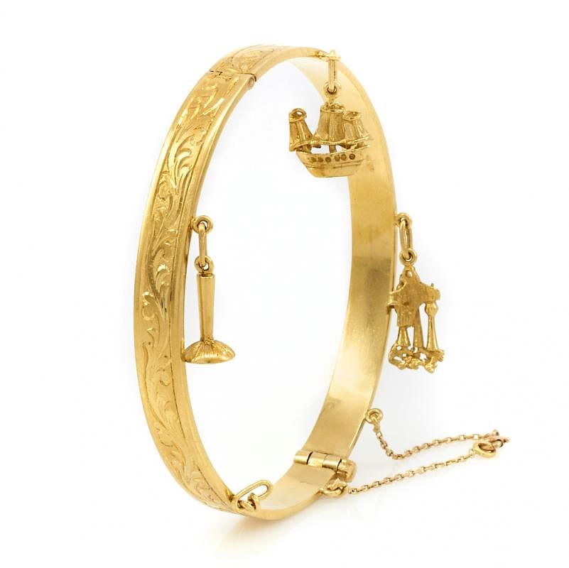 Appraisal: k Yellow gold engraved bangle bracelet with charms k Yellow