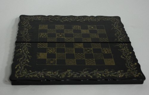 Appraisal: A papier-m ch and lacquered folding chess board the squares