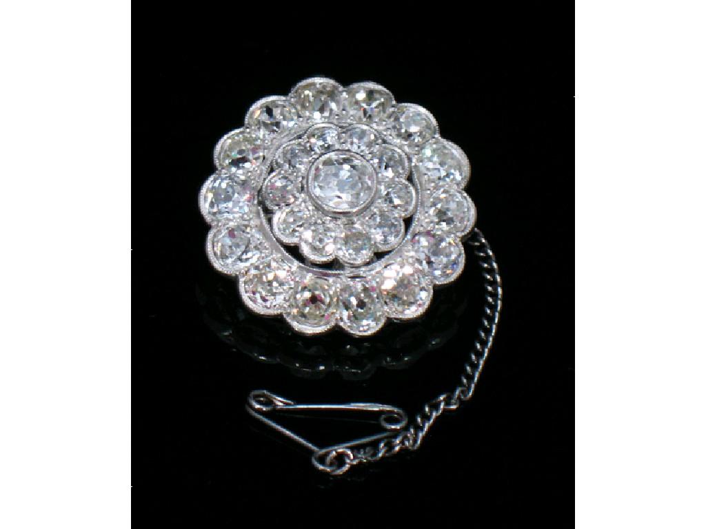 Appraisal: A DIAMOND CLUSTER BROOCH set to the centre with a