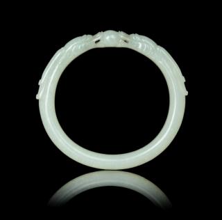 Appraisal: A Near-White Jade Bangle carved with two facing dragon heads