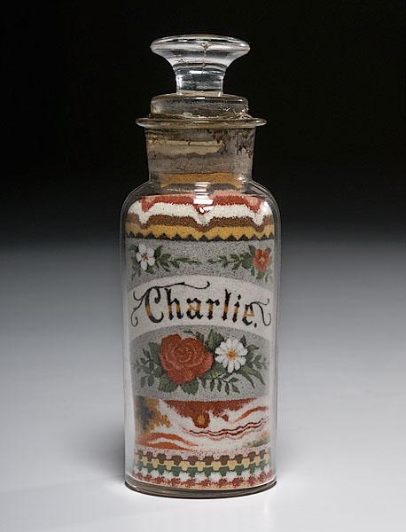 Appraisal: ANDREW CLEMENS SANDBOTTLE WITH FLORAL DECORATION in sealed apothecary jar